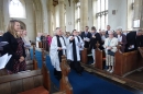 The Archdeacon escorts James back after visiting the font and ringing the bell